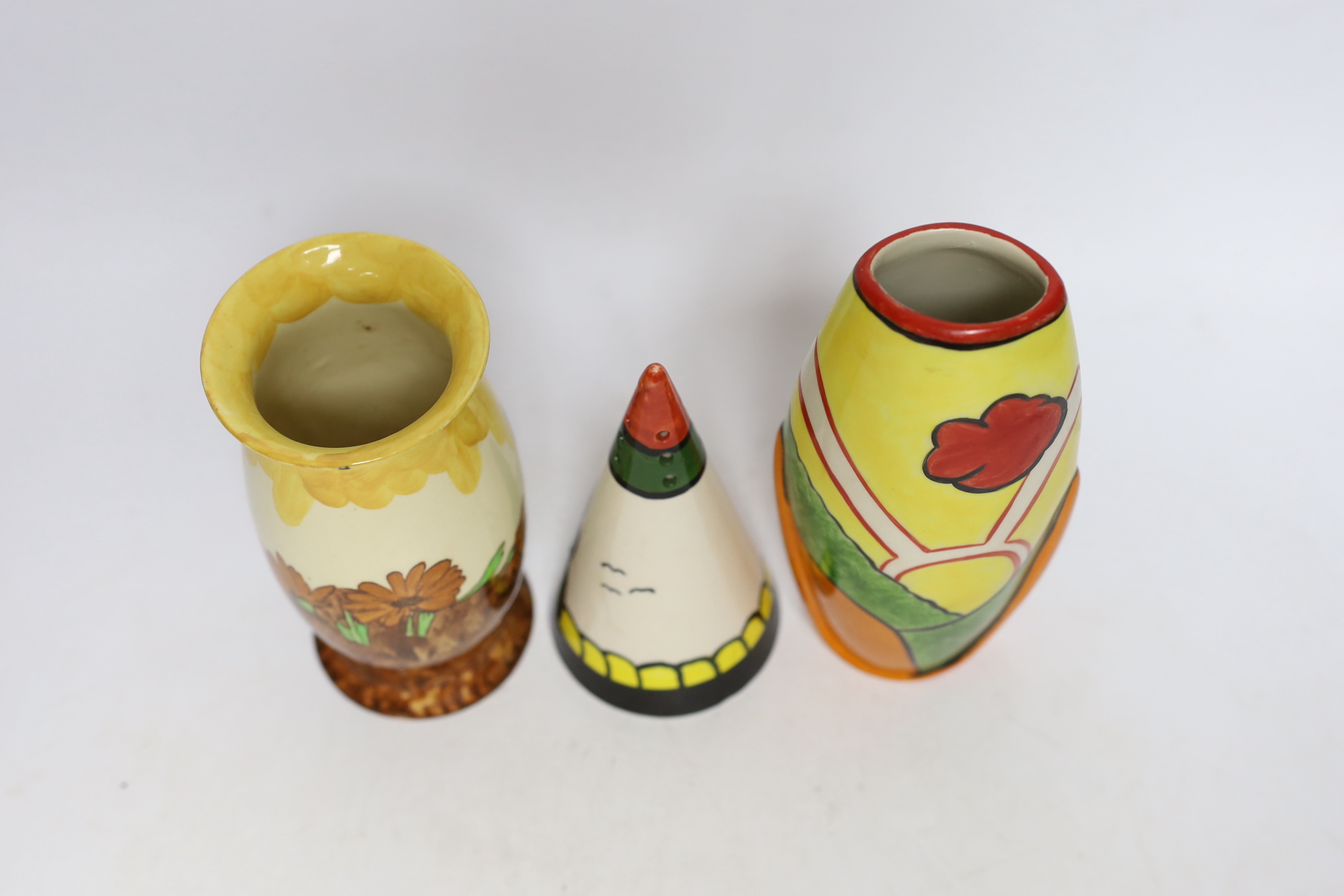 A Bernadette Eve “House” hand painted conical sugar sifter, a limited edition Heron Cross “Sunny Meadow” vase painted by Denise Steele 30/100 and a Burslem “Memory Lane” vase, all in Clarice Cliff style, tallest 18.5cm
